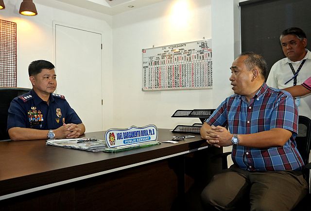 LTFRB Regional Director Ahmed Cuizon exchanges pleasantries with Senior Supt. Joel Doria, Cebu City police chief, before discussing their problem with colorum operators (CDN Photo/Lito Tecson). 