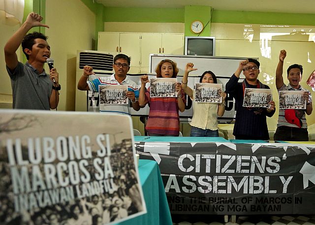 Justine Balane of the Akbayan Youth (left) and Victor Sumampong Jr., Sanlakas Youth Cebu secretary general, (5th from left) lead other members of anti-Marcos groups in the briefing in Cebu City announcing the holding of the rally to bury the Marcos effigy at the Inayawan landfill today (CDN PHOTO/LITO TECSON). 