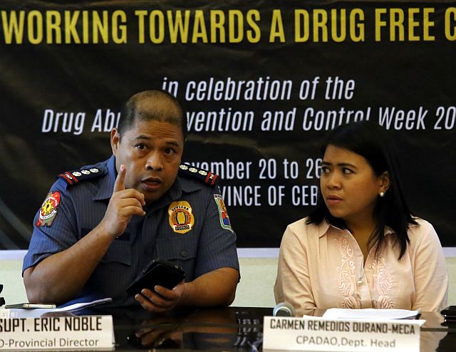 Senior Supt. Eric Noble, Cebu Provincial Police Office chief, (left) and Carmen Durano Meca, Cebu Provincial Anti-drug abuse office (CPADAO) director, discuss how to stop the increase of minors being involved in illegal drugs in the province in a press briefing at the Capitol (CDN PHOTO/JUNJIE MENDOZA). 