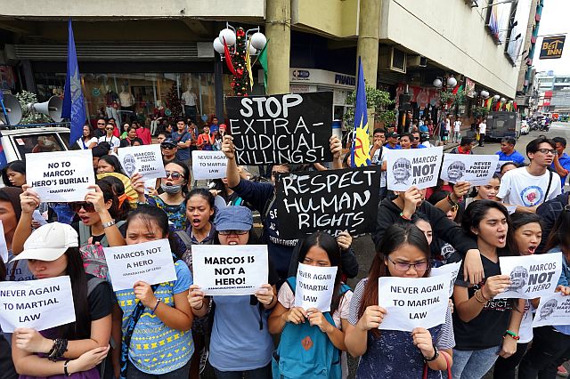 Militants shout slogans as they stage their Black Friday protest against the surprise burial of the late dictator and former president Ferdinand Marcos at the Libingan ng mga Bayani. (CDN PHOTO/JUNJIE MENDOZA)