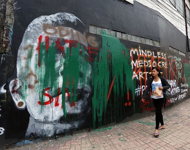 The vandalized mural along Escario Street. (CDN PHOTO/JUNJIE MENDOZA)