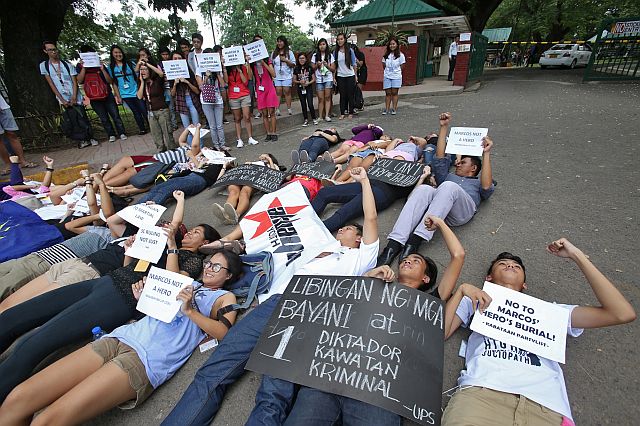 LIE-IN.  About 50  students of the University of the Philippines (UP) Cebu gather for a lie-in at the road just outside of the main gate of the university, located in Barangay Lahug, Cebu City, to protest the surprise burial, with military honors,  of the late dictator Ferdinand Marcos at the Libingan ng mga Bayani at noon yesterday, Nov. 18, 2016.