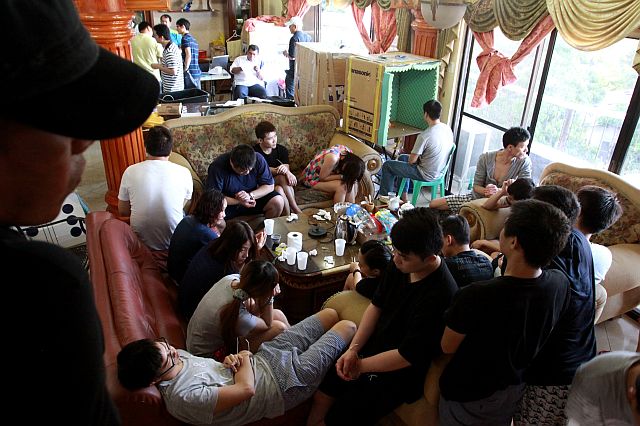 Twenty-four Taiwanese nationals were arrested by agents of the National Bureau of Investigation in cooperation with the National Police Agency of Taipei City and the Taipei Economic and Cultural Office for alleged online extortion and fraud inside a rented house in a subdivision in Barangay Guadalupe(CDN PHOTO/JUNJIE MENDOZA). 