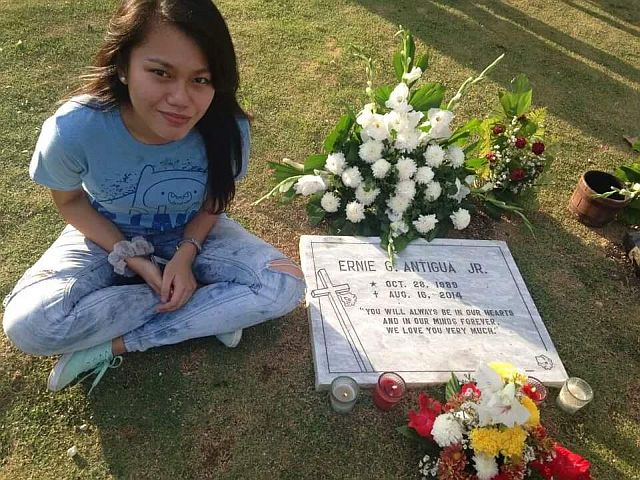 SISTER TALK. May Roxanne Antigua sits beside the grave of her older brother Ernie Jr. at the Manila Memorial Park in Liloan, Cebu.  The family has never spoken publicly about Ernie since his suicide in 2014.  (CONTRIBUTED PHOTO)