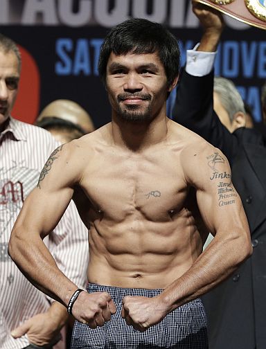 Filipini ring icon Manny Pacquiao, poses on the scale during yesterday’s official weigh-in in Las Vegas. Pacquiao, the aging, 8-division world champion will fight Jessie Vargas today for the latter’s WBO welterweight crown at the Thomas and Mack Center. (AP)