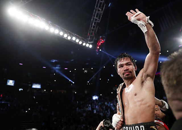 Manny Pacquiao celebrates after defeating Jessie Vargas in their WBO welterweight title boxing match in Las Vegas.  (AP) 