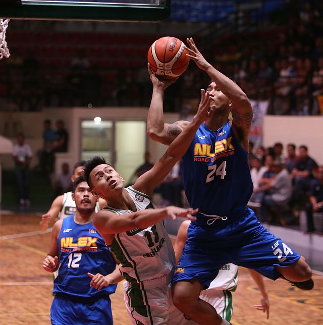 NLEX forward Glenn Khobuntin charges into the defense of Anmar Cosari of UV in their  Recoletos Invitational Cup game at the USJ-R Coliseum in Basak, Cebu City. (CDN PHOTO/LITO TECSON)