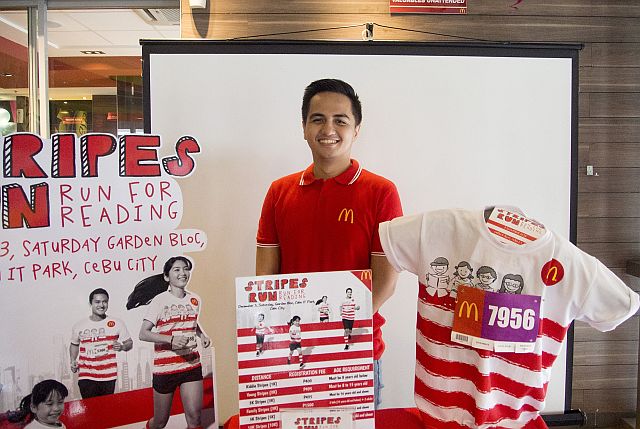 George Tongol, McDonald’s Local Store Marketing Coordinator, shows off the singlet for the upcoming Stripes Run. (CDN PHOTO/CHRISTIAN MANINGO)