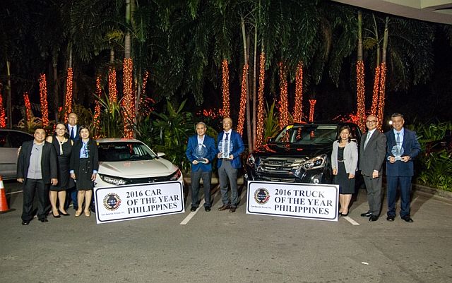 From left, Niel Pagulayan, Mika Fernandez-David and Ronnie Trinidad, directors of CAGI;  Vernadeth Hiyao, Department Head, Product and Sales Development of Honda Cars Philippines Inc.; Delfin de Guzman, Vice President for Corporate Strategy of HCPI; Shohiro Sakoda, Executive Vice President of Isuzu Philippines Corp.; Nora Liquido, Corporate Communication Manager of IPC; Robby Consunji, President of CAGI; and Joseph Bautista, Sales Division Manager of IPC with the Car of the Year and Truck of the Year winner (CONTRIBUTED PHOTO). 