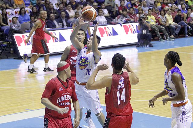 Cebuano Roger Pogoy of TNT KaTropa splits the defense of Barangay Ginebra in his first game in the PBA (PBA IMAGES). 