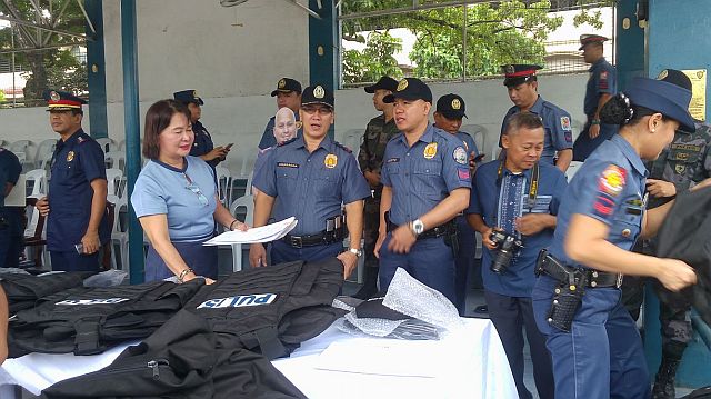 Policemen distributes the bulletproof vests after the flag-raising ceremony at PRO-7. (CDN PHOTO/ADOR VINCENT S. MAYOL)