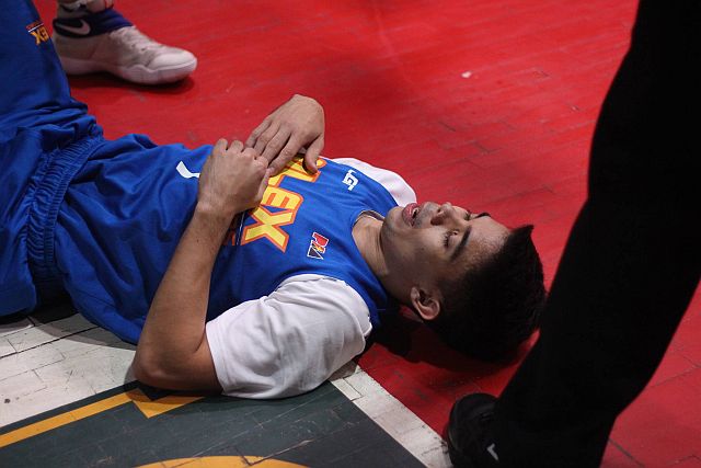 NLEX point guard Emman Monfort lies on the hard court at the USJ-R Coliseum after suffering an ankle injury in the first quarter of their game against the Cebu Landmasters. (CDN PHOTO/ RABBONI BORBON) 