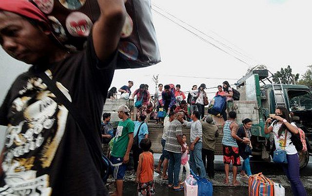 Stranded passengers from Tabaco port are evacuated by the local government in Tabaco City, Albay province on December 24, 2016 after their seafaring vessels were prohibited from sailing ahead of typhoon Nock-Ten’s expected arrival. (AFP)