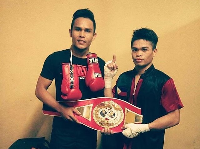 Jonas Sultan (right) and trainer Robert Eturma shows off the IBF Intercontinental super flyweight belt that the ALA Boxing Gym fighter stole from African Makazole Tete via a second-round knockout. (CONTRIBUTED PHOTO)