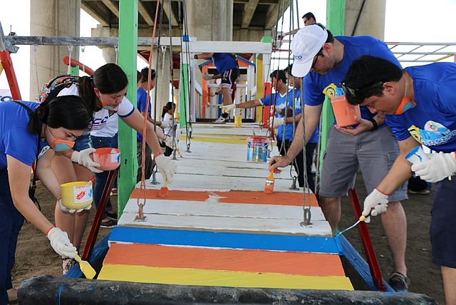  Veco employees, together with their COO Anton Mari Perdices (second from right), repaint the playground facilities. (CONTRIBUTED PHOTO). 