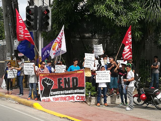 Some of the contractual workers, together with members of militant labor groups, hold a rally outside the office of the Department of Labor and Employment in Central Visayas (DOLE-7) to protest the illegal practice of end of contractualization. (CDN PHOTO/CHRISTIAN MANINGO)