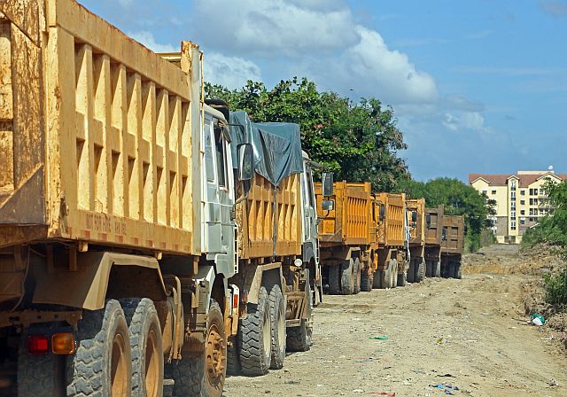 Dump trucks are on  standby near the garbage transfer station at the South Road Properties (SRP)  waiting for instruction when to remove the trash from the temporary dumping area. (CDN PHOTO/LITO TECSON)