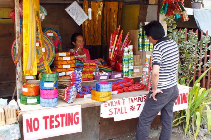 A customer looks over the firecrackers sold in one of several stalls at the Opon-Airport-Sangi Road in this December 2013 photo (CDN FILE PHOTO)