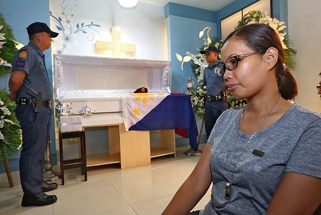 PO3 Queen Brigitte Nuñez watches over the wake of her murdered husband Senior Insp. Alexander  Nuñez at St. Peter Memorial in  Mandaue City as she grieves the death of an ideal husband and provider whom her children idolized for being a hero.  Nuñez would go beyond the call of duty to help others and  respond to any alarm, even when alone. (CDN PHOTO/JUNJIE MENDOZA)