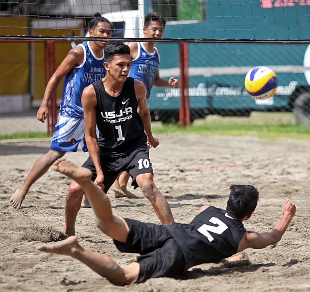 Mitch Suba of USJ-R tries to keep the play alive in a Cesafi juniors beach volleyball game against Sacred Heart School-Ateneo de Cebu at the SWU Sand Courts. (CDN PHOTO/LITO TECSON). 