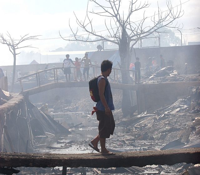 After losing their homes and most of their belongings to last year’s fire, the displaced settlers of Barangays Guizo and Mantuyong may finally start rebuilding sometime in March this year. (CDN FILE PHOTO)