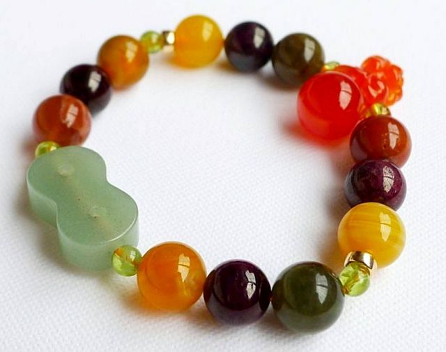 For those born in the Year of the Dragon: Orange  Carnelian (leadership, wisdom, decision-making), Rutilated Quartz (amplify thoughts, boost creativity), Green Aventurine Infinity 8 charm (well-being and emotional calm, good  fortune), with small Peridot beads (lessen stress),  and Botswana Agate beads ("Change Stone" as it is said  to be beneficial in handling change in a positive way)