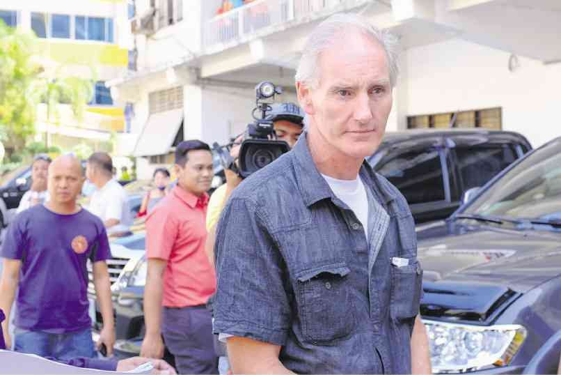 PETER Gerard Scully is being brought to the Lumbia City Jail in Cagayan de Oro where he would be detained while facing charges of child abuse and trafficking in this photo taken on Feb. 20, 2015