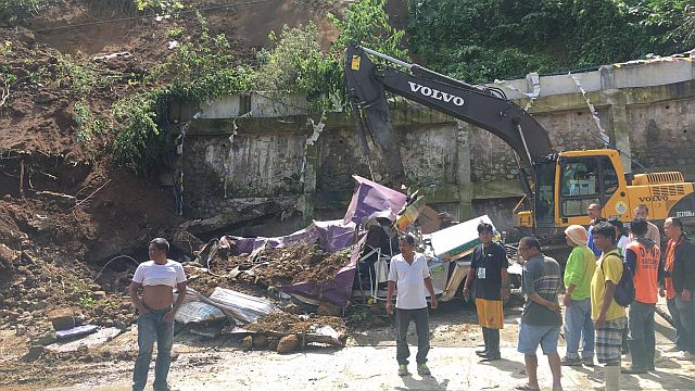 A backhoe clears out an area hit by a landslide in Sitio Garaje in Barangay Busay, Cebu City. (CDN FILE PHOTO)