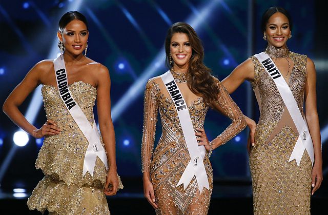 Andrea Tovar of Colombia, left, Iris Mittenaere of France, center, and Raquel Pelissier of Haiti, pose shortly after being declared the top three finalists in the Miss Universe 2016 coronation Monday, Jan. 30, 2017, at the Mall of Asia in suburban Pasay city, south of Manila, Philippines. Iris Mittenaere was crowned the Miss Universe 2016 while Raquel Pelissier was the runner-up. (AP Photo/Bullit Marquez)