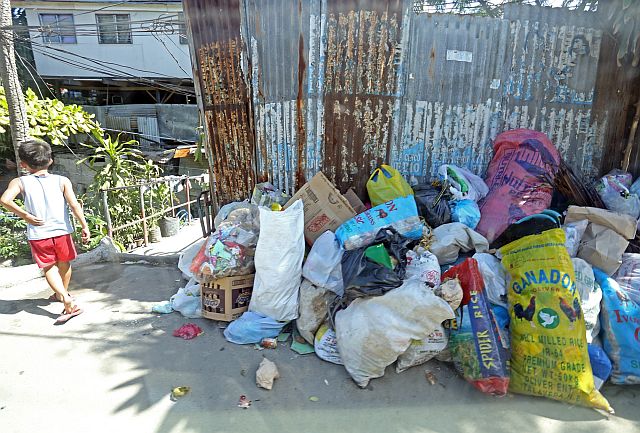 Even while the Plastic Bag Ordinance banning the use of plastic in Mandaue City has been reinforced, mounds of uncollected garbage, such as this one in Barangay Tipolo, continue to litter parts of the city, causing massive flooding due to clogged waterways. (CDN PHOTO/LITO TECSON)