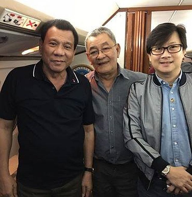 President Rodrigo Duterte (left), Fr. Edwin Bacaltos (center) and Secretary Michael Dino are together on board the presidential plane going to Cebu to award land titles to dwellers of Eversley Sanitarium. (PHOTO FROM FR. EDWIN BACALTOS' FB)