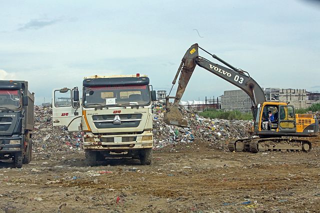 One of the dumptrucks of Jomara Konstruckt Corp. hauls garbage dumped at the South Road Properties in this Jan. 2, 2017 photo. cdn file photo