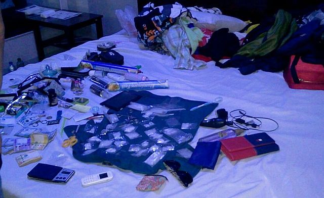 Illegal drugs and paraphernalia seized from inside the room of a motel in Mandaue City that was occupied by alleged drug dealer Francis Omolon are displayed atop the room’s bed for photo documentation purposes.  (CDN PHOTO/ NORMAN MENDOZA)