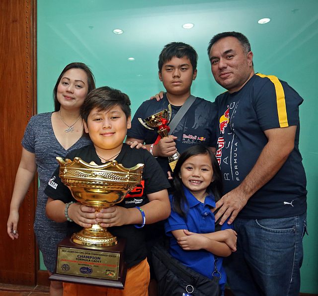 KARTING CHAMPION ASIAN KAZ ROMOFF/JAN.07,2017:Khazart William Hisoler Romoff 10 years old hold his troophy after he was Champion in 2016 Asian Karting Open Championship series in Macau together with his older brother Keondrei Romoff ,mother Maria Arlyne ,father Santiago Clarence and baby sister Kyaniah Marie pose after their press conference at Casino Español.(CDN PHOTO/LITO TECSON)