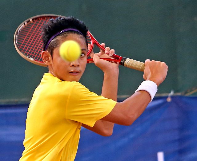 Ibarra Ortega plays a sliced backhand to Jose Maria Pague during their 16-under boys semifinal game in the Cebuana Lhuillier tennis tournament at the Citigreen Tennis Resort in Labangon. Paque won to make the final. (CDN PHOTO/LITO TECSON)