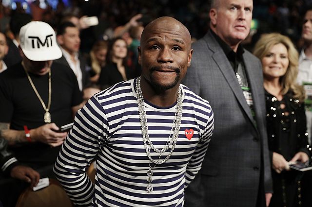 Retired boxer and boxing promoter Floyd Mayweather Jr. attends a fight between Carl Frampton, of Northern Ireland, and Leo Santa Cruz, Saturday, Jan. 28, 2017, in Las Vegas. Mayweather. says facing UFC star Conor McGregor in a boxing ring "can happen" and is something that would "give the fans what they want to see."  In a question-and-answer session Saturday in England, McGregor said he plans to put his UFC career on hold to pursue boxing and a bout with Mayweather, who hasn't fought since 2015. (AP Photo/John Locher)