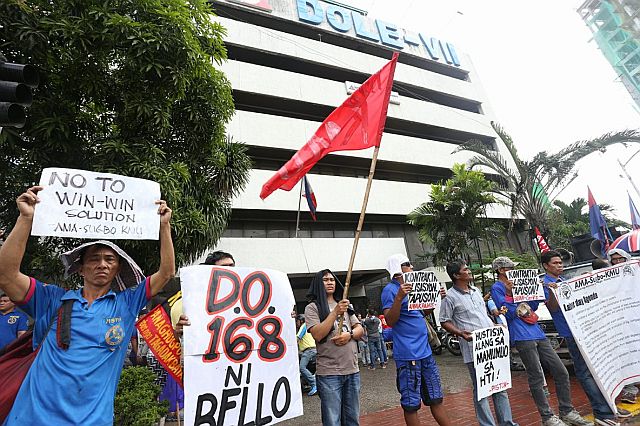 Members of the group Kilusang Mayo Uno together with Gabriela and Alyansang Makabayan staged a protest infront of the Dapartment of Labor DOLE-7 to abolish contractualization. | Photo by Junjie Mendoza