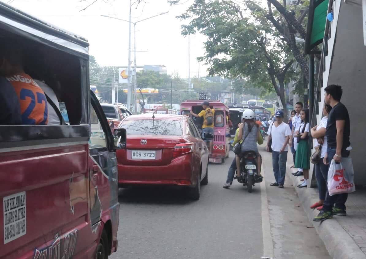 Passengers wait for transportation at N. Bacalso Avenue in Cebu City. Few jeepneys now ply the area as other drivers join the nationwide transport strike. (CDN PHOTO/LITO TECSON)