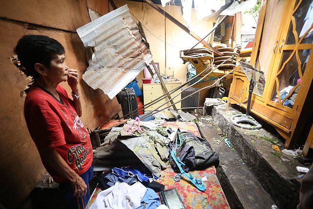 Segundina Cavan, owner of the houses that was damaged by a falling crane along N. Bacalso Ave. in Cebu City appealed to the developer to pay them for the damages. (CDN PHOTO/LITO TECSON)