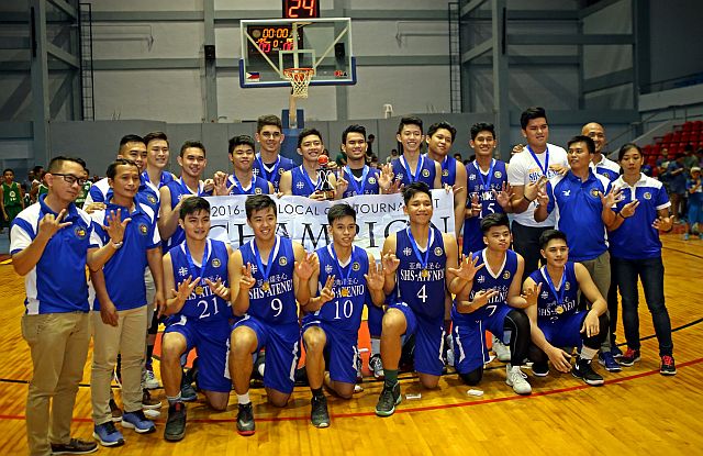 Players and team officials of the Sacred Heart School-Ateneo de Cebu Magis Eagles flash the number seven sign after they captured their seventh straight title in the Cebu National Basketball Training Center Division 1 via a 66–61 win over the University of the Visayas Baby Lancers yesterday. CDN PHOTO/LITO TECSON