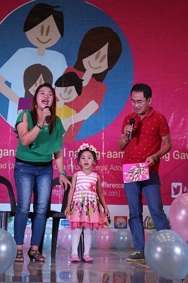 Mr. and Mrs. German and Carmel Desuyo, adoptive parents, render a song entitled “For My Baby” and dedicate it to their four-year-old daughter, Therese Anne, during the opening salvo of Adoption Consciousness Week celebration. (CONTRIBUTED PHOTO)