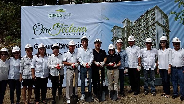 Rafaelito Barino (sixth from left) and his wife, Fe, (fifth from left) Duros Land Properties Inc. president and vice president respectively, lead the launching of The Woodlands Resort Communities and groundbreaking of One Tectona Tower in Yati, Liloan. CDN PHOTO/JEFF RUFFOLO