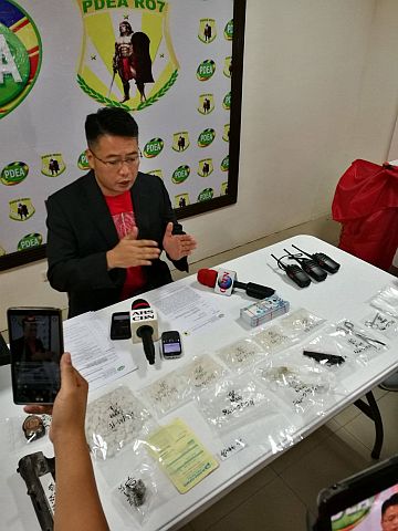 Director Yogi Filemon Ruiz of the Philippine Drug Enforcement Agency in Central Visayas (PDEA-7) shows the illegal drugs and handheld radios confiscated during a recent drug raid in Cebu.  