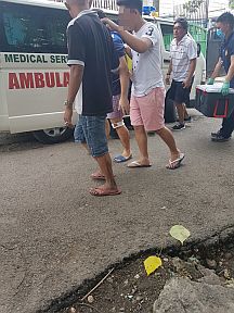 Dr. Julian Iñaki Larrazabal-Garcia is being led into a waiting ambulance by responding relatives and policemen after he sent a message on Facebook to his brother saying that he was in Carcar City.  Witnesses claim that the 26-year-old doctor was thrown off a speeding white van some three hours after he was snatched near the Cebu Doctors University Hospital in Cebu City.  CONTRIBUTED PHOTO
