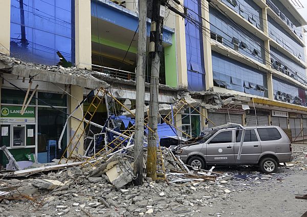 Fallen debris from a building are seen Saturday, Feb. 11, 2017 following a powerful nighttime earthquake that rocked Surigao city, Surigao del Norte province in southern Philippines. The late Friday quake roused residents from sleep in Surigao del Norte province, sending hundreds to flee their homes. (AP Photo)