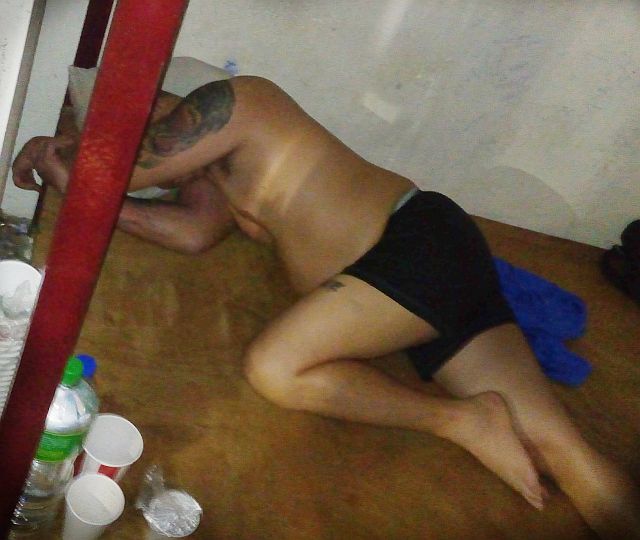 Extortion suspect Avednigo Origenes avoids the cameras as he takes a nap inside the NBI cell. (CDN PHOTO/LITO TECSON)