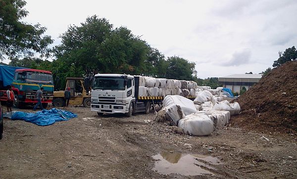 Trucks prepare to transport the shredded plastic wastes in Barangay Tingub, Manadue City, to the Cebu International Port where they will be loaded to the waiting cargo ship MV Christina. 
