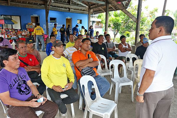 In this photo taken on Feb. 16, 2017, Cebu City Councilor Dave Tumulak (right) talks with the tanods and garbage loaders of Barangay Bulacao headed by Barangay Captain Rodrigo Jabellana (seated left) after the village workers underwent a surprise drug testing, which is part of the internal cleansing being done by the city government in the barangays following the decision of Mayor Tomas Osmeña to cut the honorarium of barangay tanods and garbage loaders. CDN PHOTO/JUNJIE MENDOZA