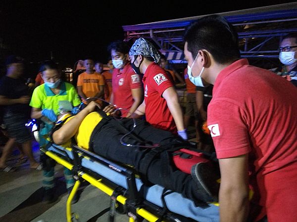 Cebu City’s emergency responders rush an injured passenger to a waiting ambulance to be transported to the hospital. Survivors of the sea mishap arrived at Pier 4 pre-dawn on Sunday. 