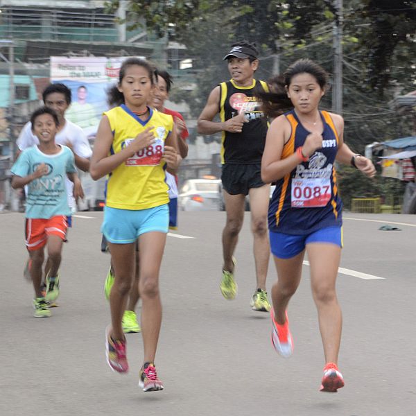 Siblings Cherry and Lovely Andrin run side-by-side in the “I Love Run: Born From the Heart” footrace.  